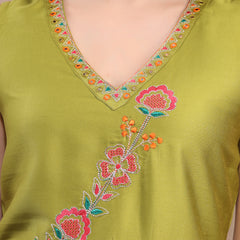 Close-up embroidery work on green kurta fabric
